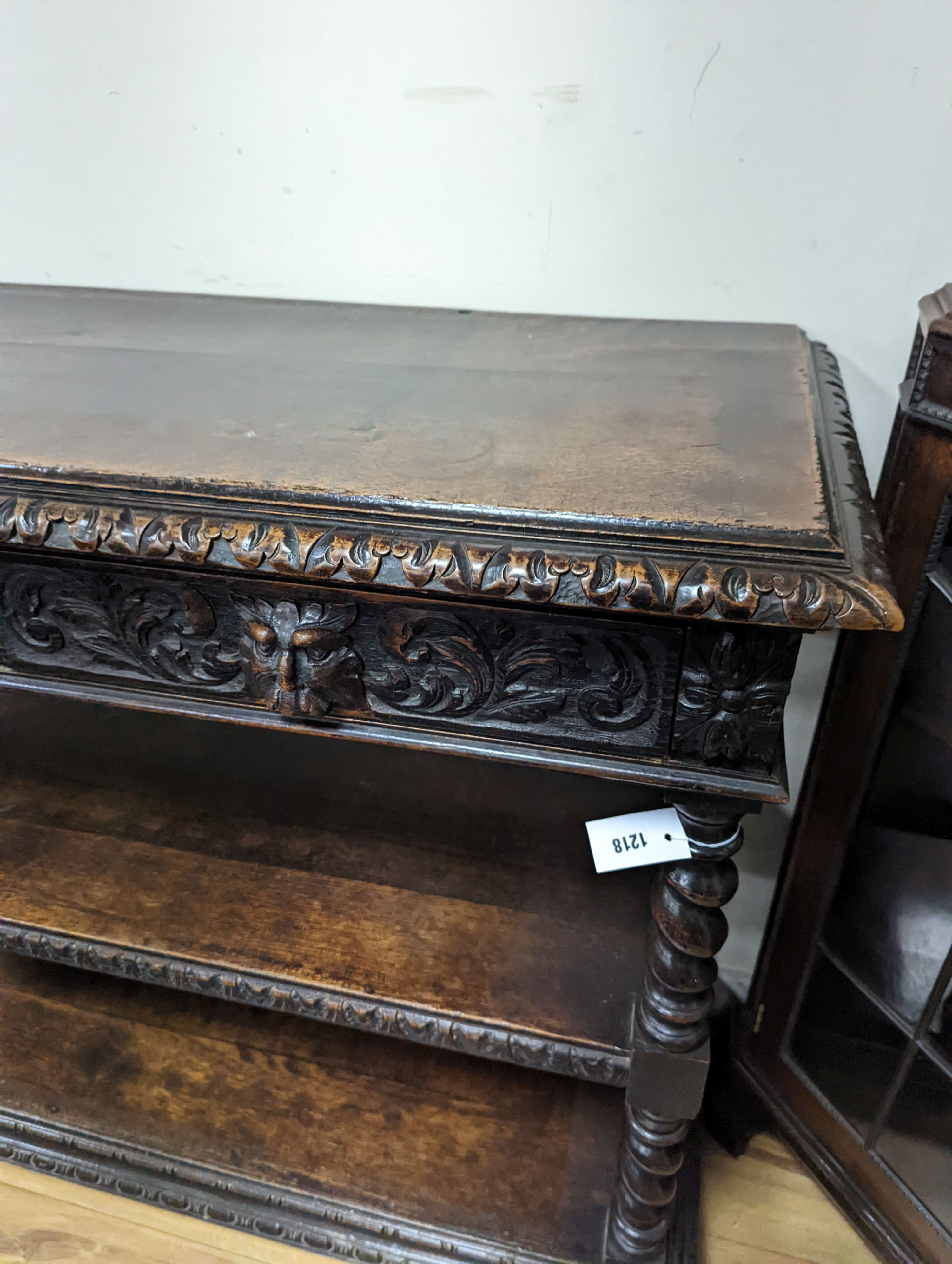 A 19th century Flemish carved oak three tier buffet, length 121cm, depth 46cm, height 98cm